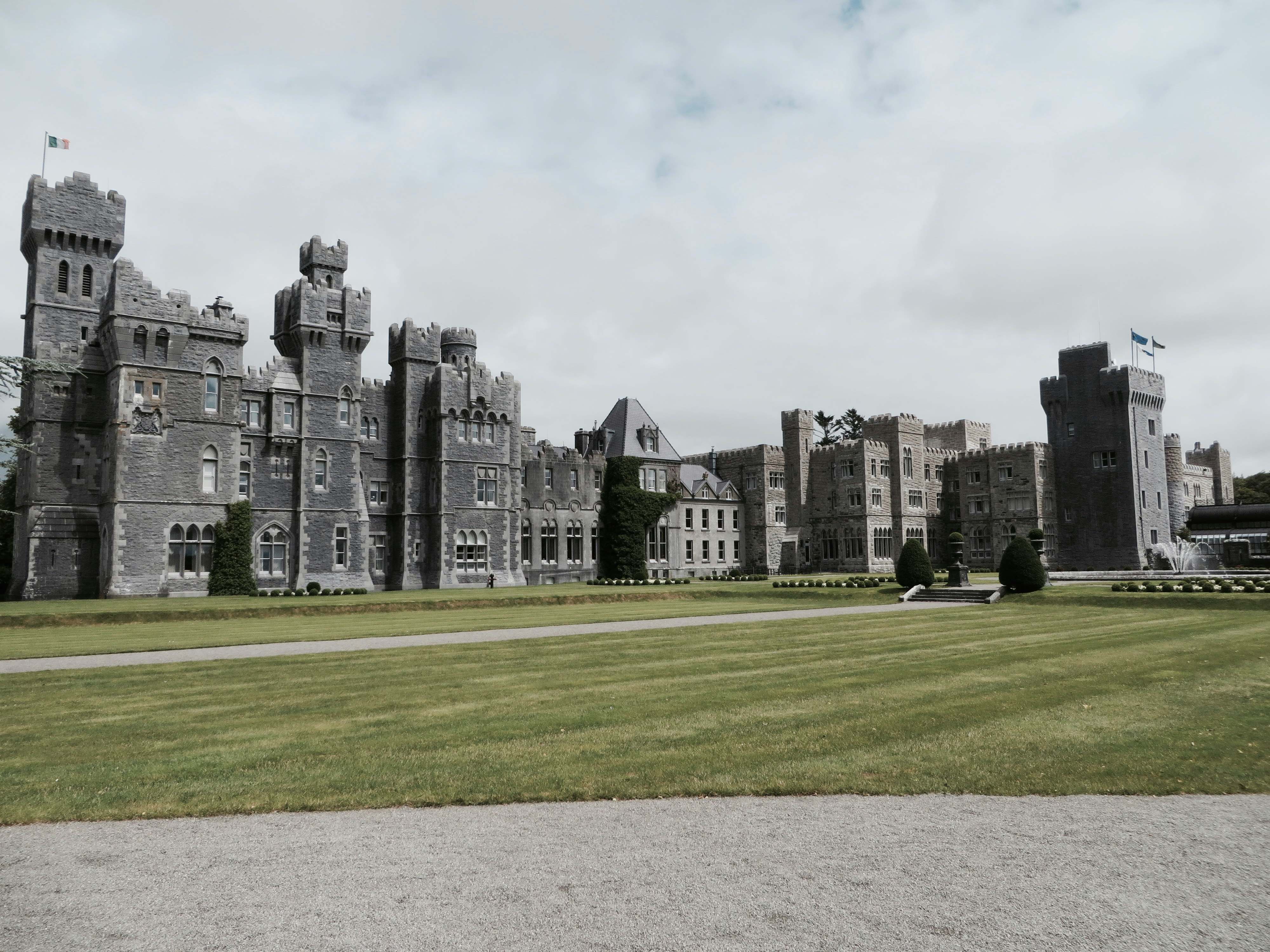 landscape photo of gray concrete mansion under blue sky